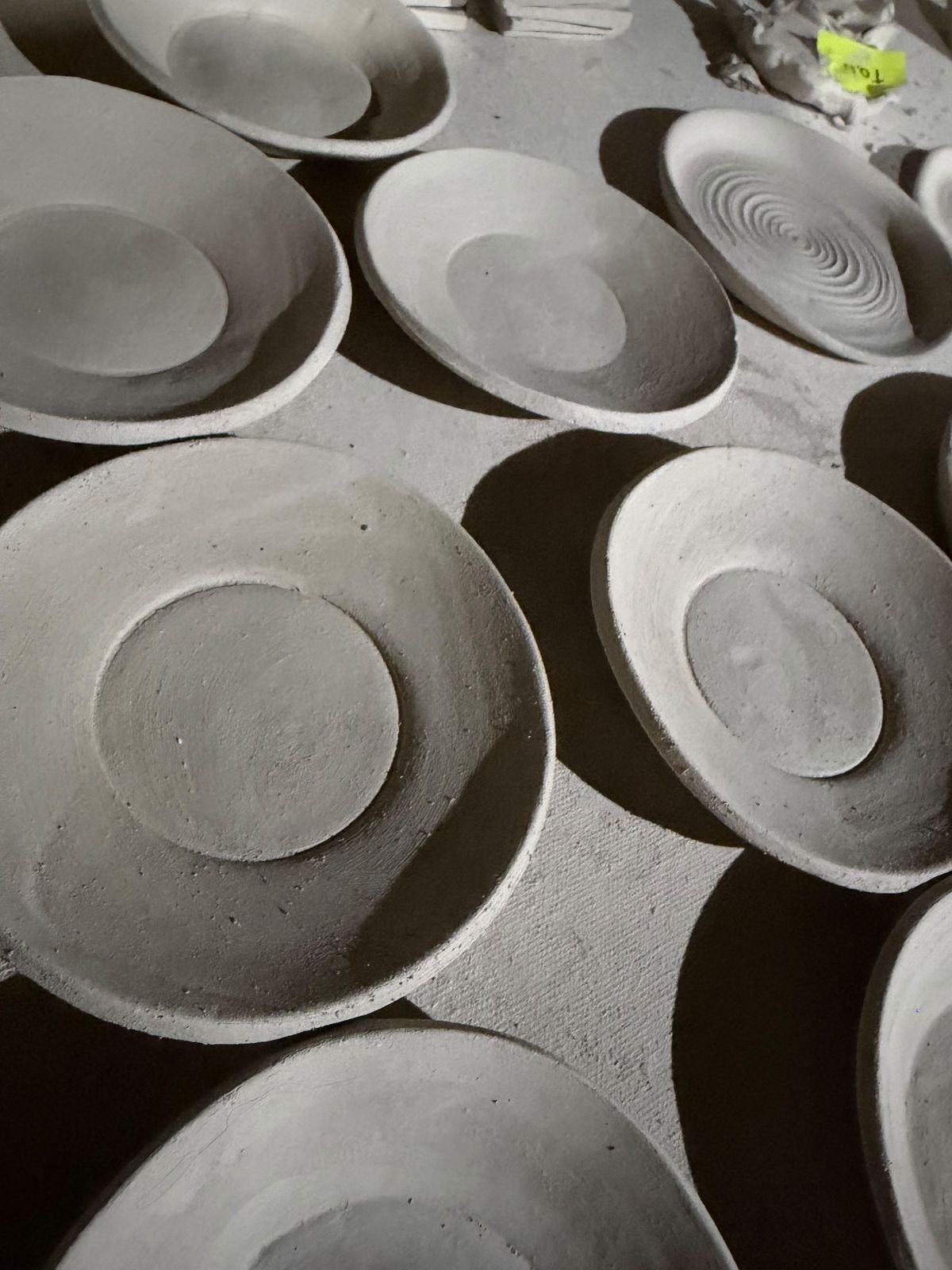 Freshly made clay bowls drying before their first firing